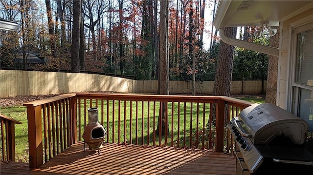 deck featuring grilling area and a lawn