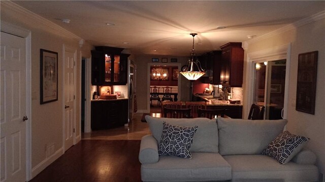 living room with wood-type flooring and ornamental molding