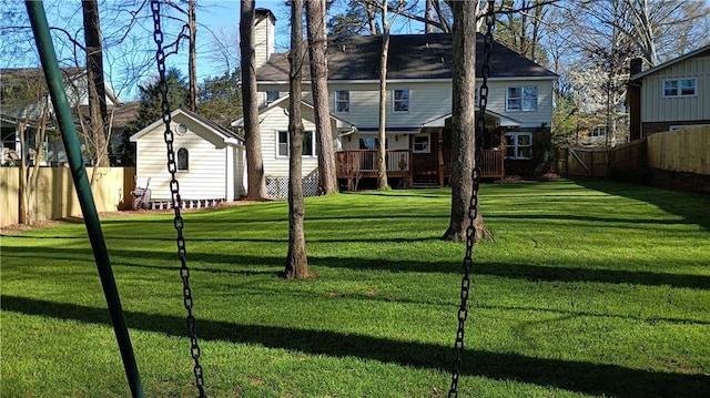 view of yard featuring an outdoor structure and a wooden deck