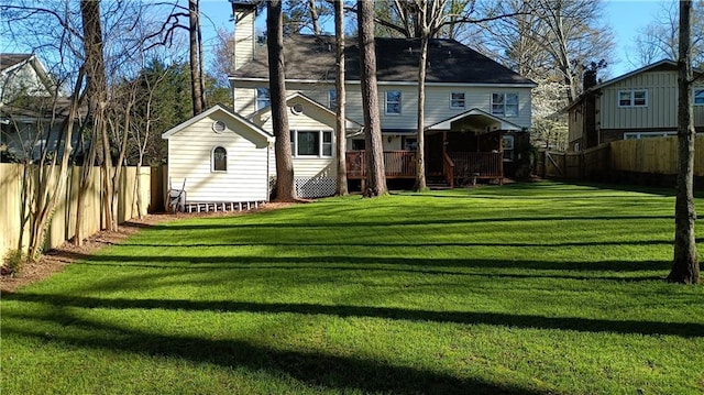 back of house with a yard and a deck