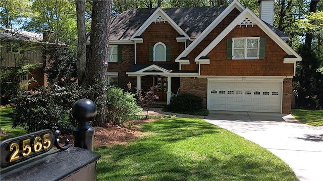 view of front of home with a front lawn and a garage