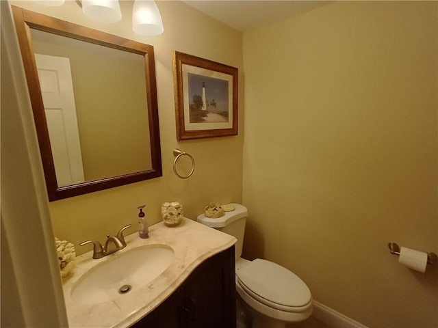 bathroom featuring toilet and vanity