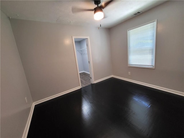 empty room with ceiling fan and hardwood / wood-style flooring