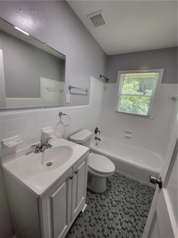 full bathroom featuring vanity, shower / washtub combination, tile walls, toilet, and decorative backsplash