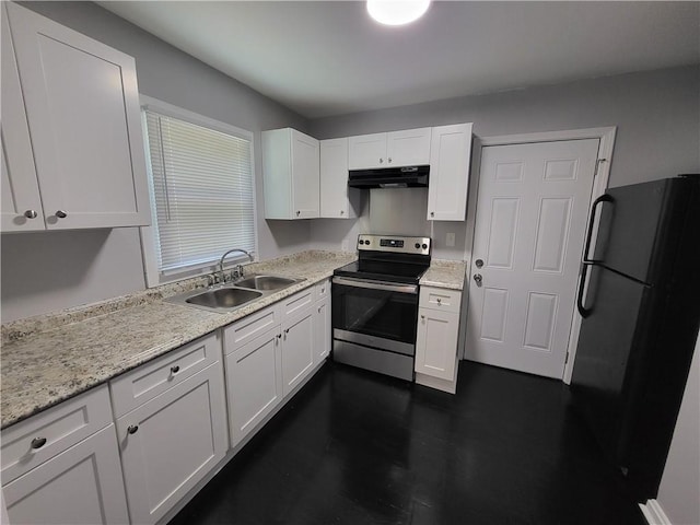 kitchen featuring stainless steel electric range oven, white cabinets, light stone counters, sink, and black refrigerator