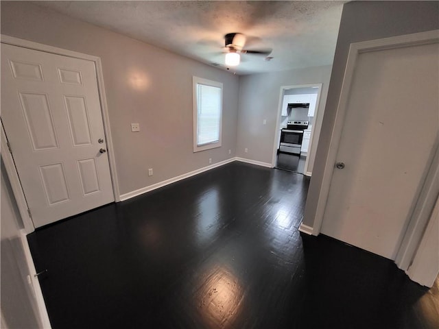 interior space featuring dark wood-type flooring and ceiling fan