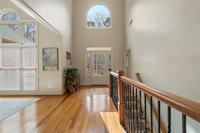 entrance foyer featuring light wood-style floors, visible vents, and a healthy amount of sunlight