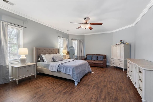 bedroom with visible vents, dark wood-type flooring, ornamental molding, and a ceiling fan