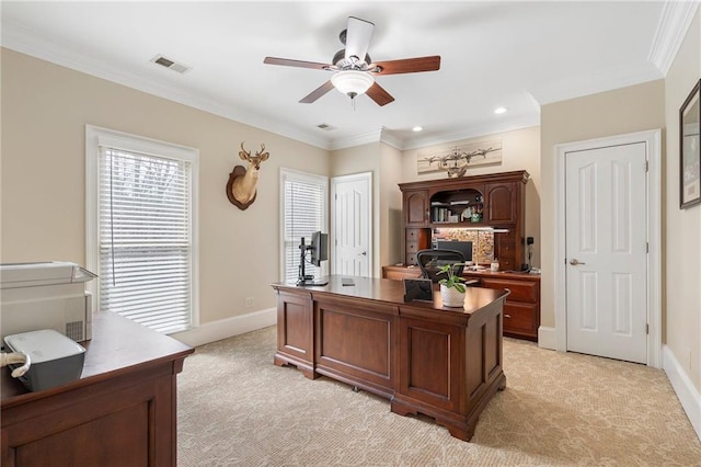 office area featuring visible vents, crown molding, baseboards, ceiling fan, and light colored carpet