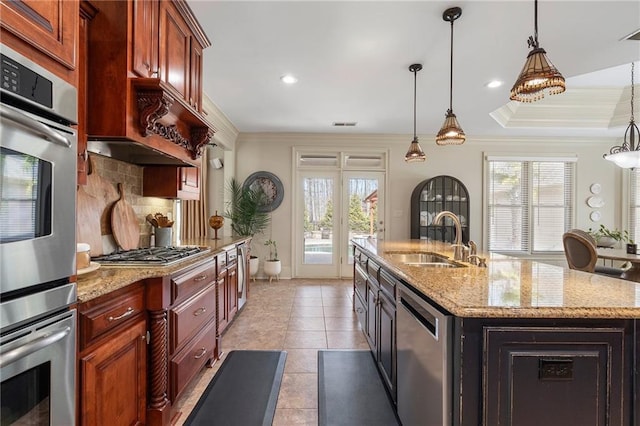 kitchen featuring a sink, appliances with stainless steel finishes, crown molding, decorative backsplash, and hanging light fixtures