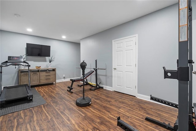 workout room with recessed lighting, baseboards, and dark wood-type flooring