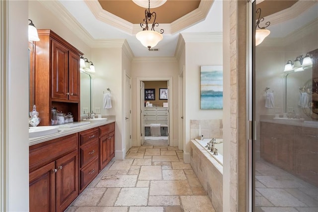 bathroom featuring double vanity, a sink, stone tile flooring, a garden tub, and a raised ceiling