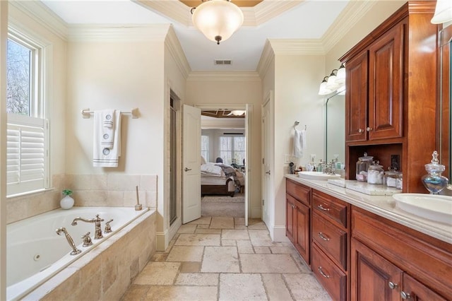 ensuite bathroom featuring visible vents, ensuite bathroom, a sink, stone tile floors, and double vanity