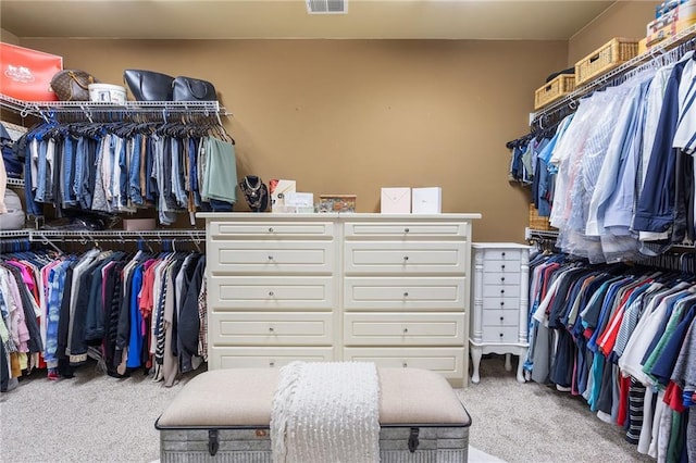 walk in closet featuring visible vents and carpet