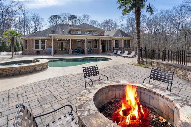 view of pool featuring a fenced in pool, a fire pit, fence, an in ground hot tub, and a patio