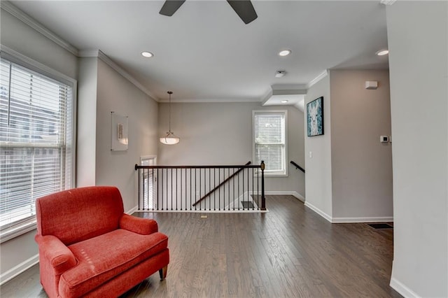 living area featuring recessed lighting, ornamental molding, an upstairs landing, wood finished floors, and baseboards