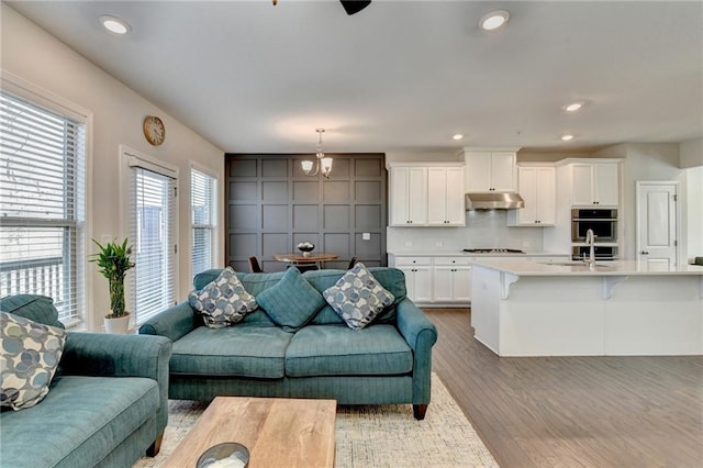 living area with wood finished floors and recessed lighting