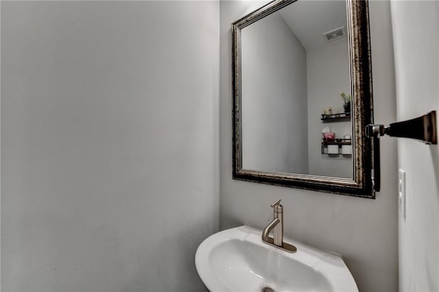 bathroom with visible vents and a sink