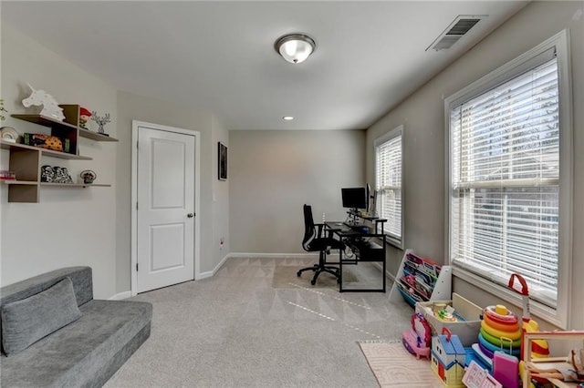 carpeted home office featuring baseboards and visible vents