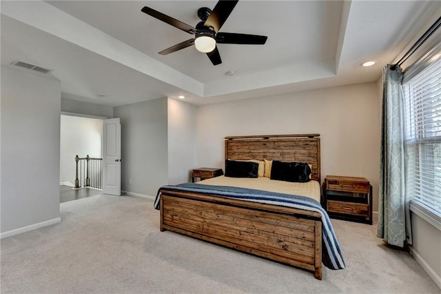 bedroom featuring carpet, recessed lighting, a raised ceiling, visible vents, and baseboards