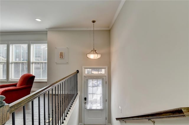 foyer entrance featuring ornamental molding and recessed lighting