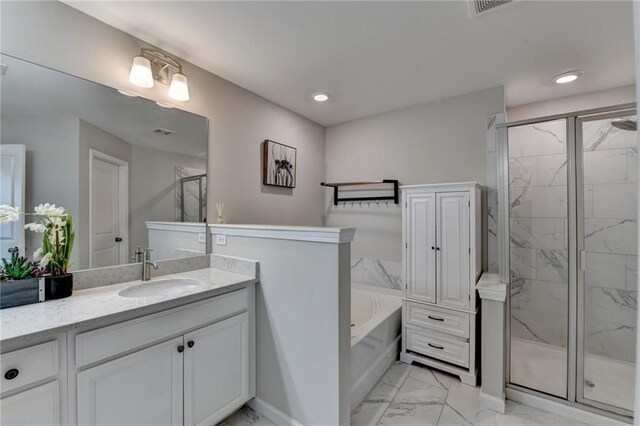 full bathroom with a marble finish shower, marble finish floor, a garden tub, vanity, and recessed lighting