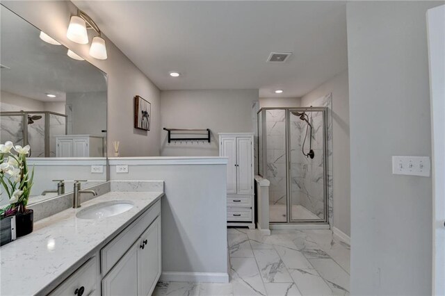 full bath with marble finish floor, visible vents, a stall shower, vanity, and baseboards