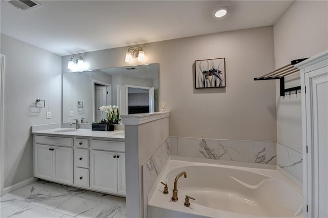 bathroom with a garden tub, vanity, visible vents, baseboards, and marble finish floor