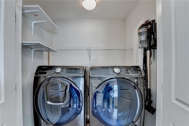 washroom featuring laundry area and separate washer and dryer