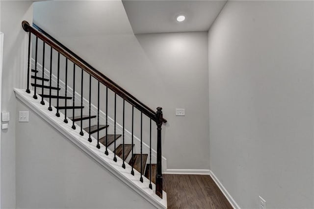 stairs featuring baseboards and wood finished floors