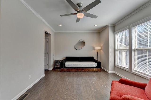 interior space featuring ornamental molding, multiple windows, wood finished floors, and baseboards