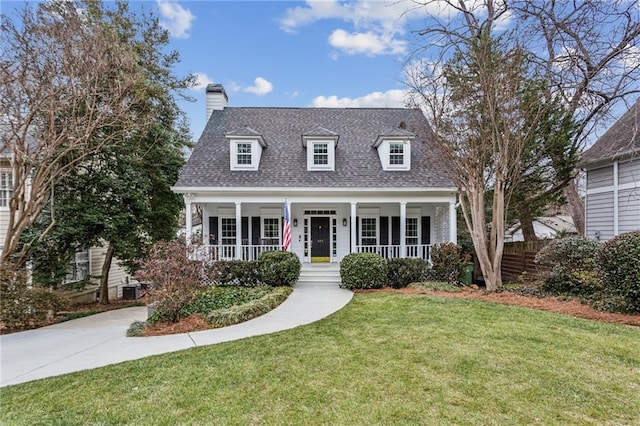 cape cod home featuring a porch and a front lawn