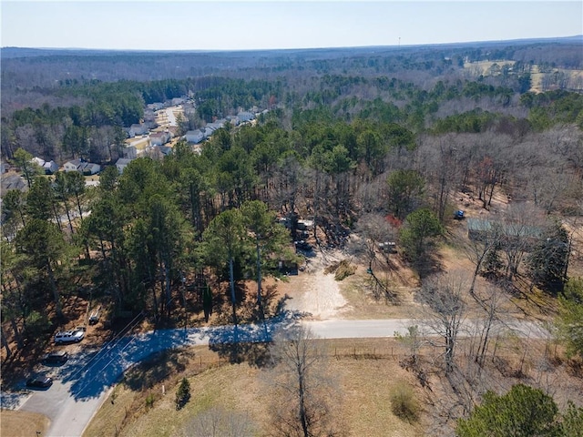 bird's eye view featuring a wooded view