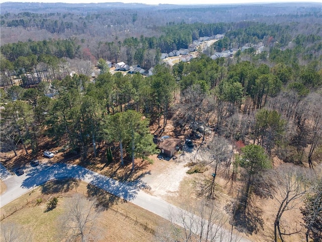 bird's eye view featuring a wooded view