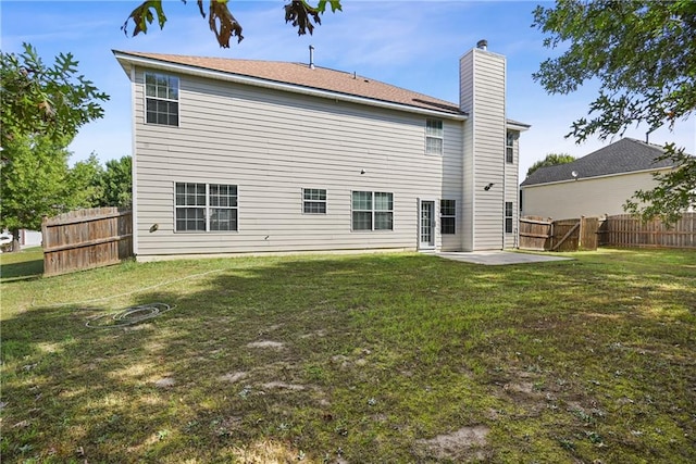 back of house with a patio and a yard