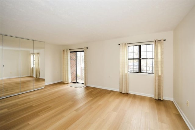 spare room featuring light wood-type flooring