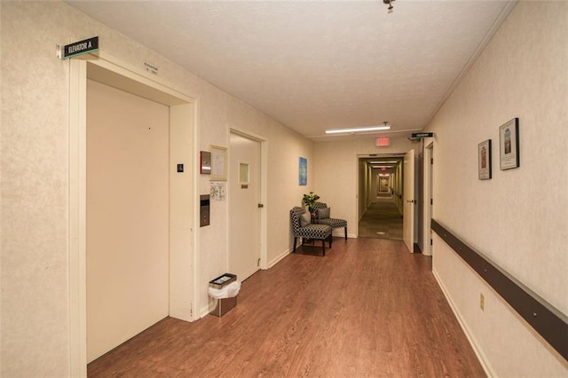 corridor featuring dark hardwood / wood-style flooring and elevator