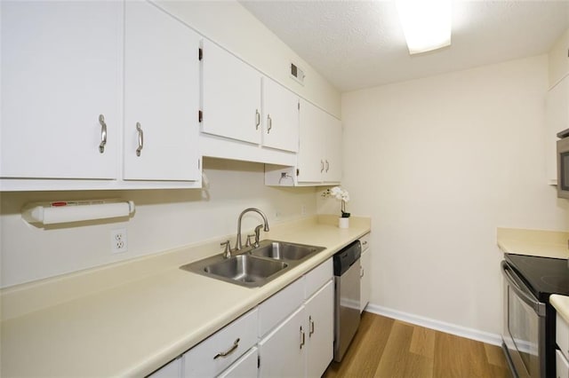 kitchen featuring sink, white cabinetry, wood-type flooring, black / electric stove, and stainless steel dishwasher