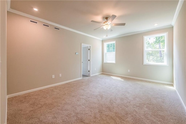 empty room with ceiling fan, ornamental molding, and light carpet