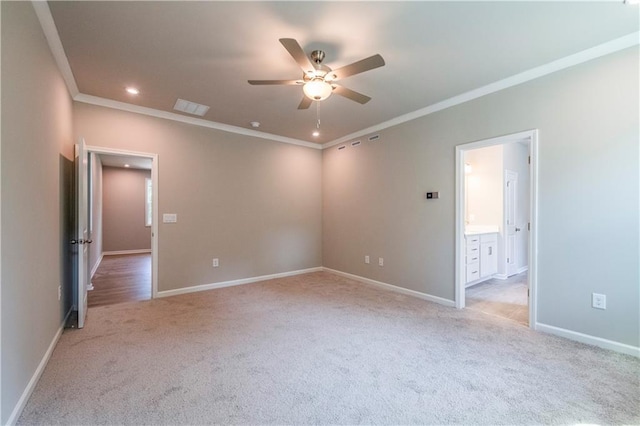 unfurnished room with light colored carpet, ceiling fan, and crown molding