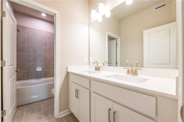 full bathroom with tile patterned floors, vanity, toilet, and tiled shower / bath