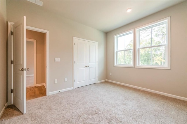 unfurnished bedroom featuring carpet flooring and a closet