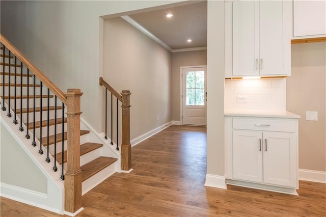 foyer entrance featuring wood-type flooring and ornamental molding