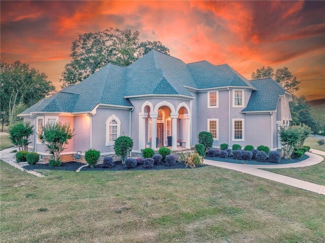 french country home with a yard