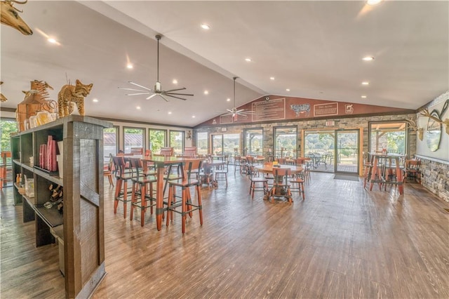 dining space with lofted ceiling, hardwood / wood-style flooring, and ceiling fan