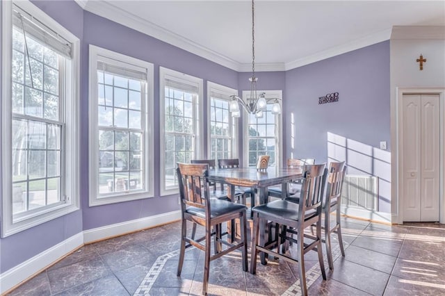 dining room with crown molding and a chandelier