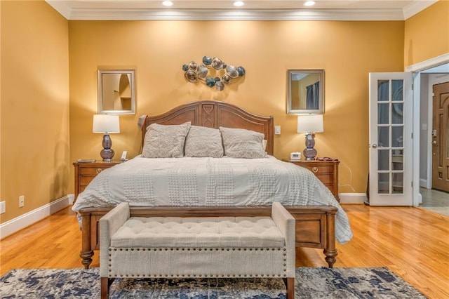 bedroom with ornamental molding and wood-type flooring