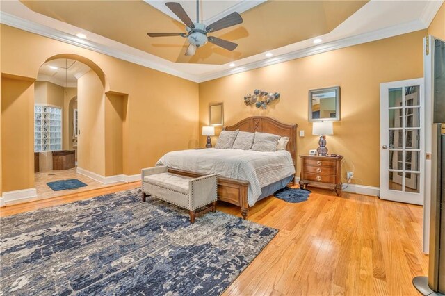 bedroom with ornamental molding, light hardwood / wood-style flooring, and ceiling fan