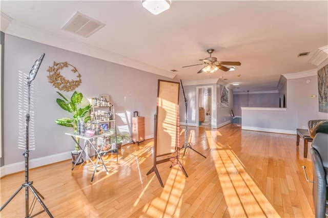 living room with ceiling fan, hardwood / wood-style flooring, and ornamental molding