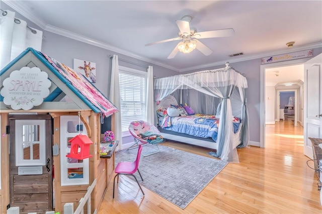 bedroom featuring ornamental molding, light hardwood / wood-style flooring, and ceiling fan